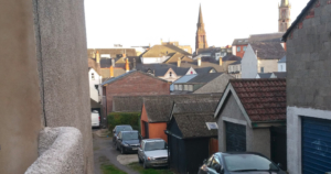 new mews house as seen from the other end of the lane; spires of the churches of Bangor with roofscape in the background